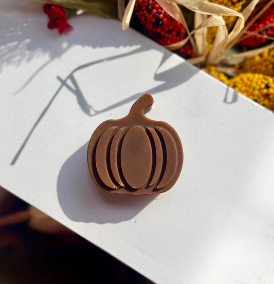 A small brown pumpkin shaped soap sitting on a white background.