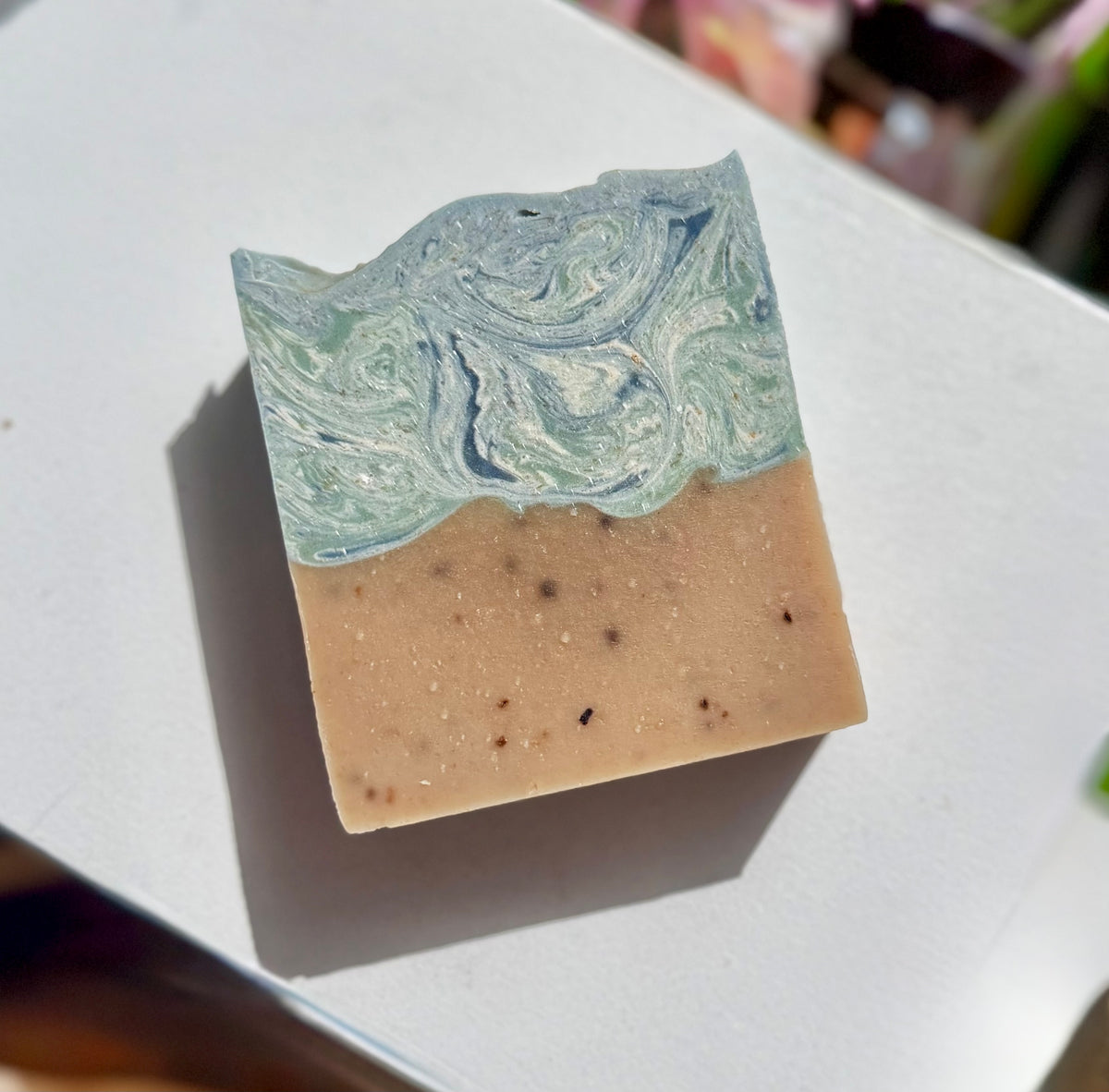 Blue and tan bar of soap on white background